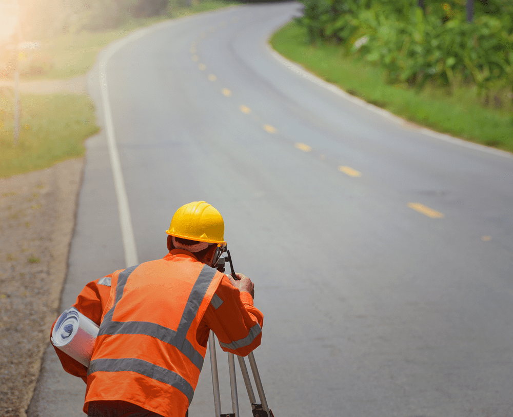 Surveyor working by a rural road