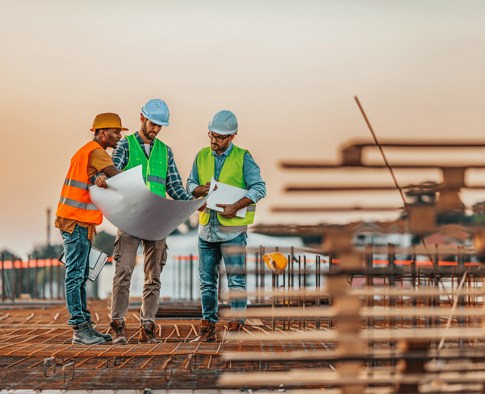 Team examining blueprints at building site